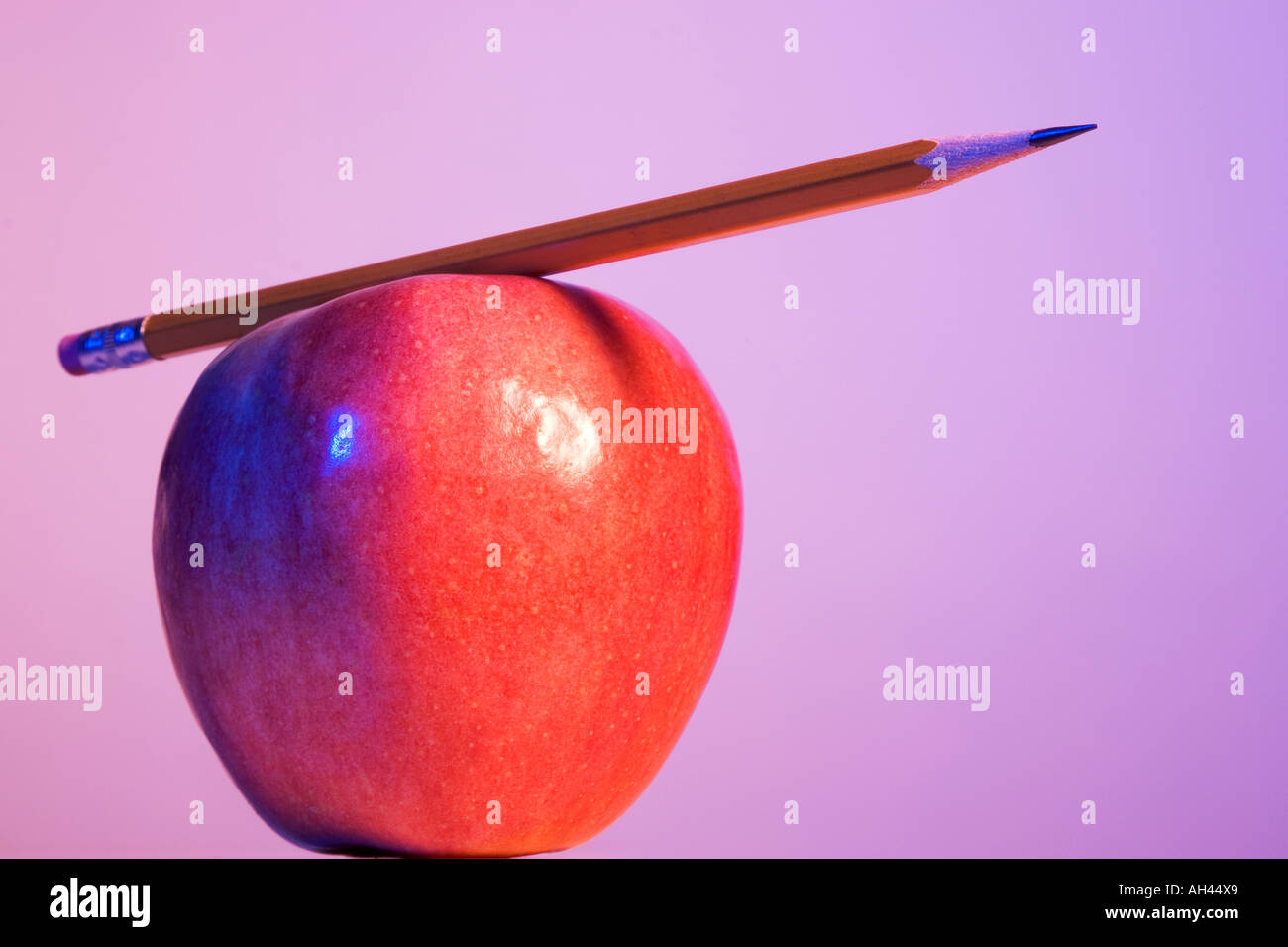 Pencil placed on an apple Stock Photo