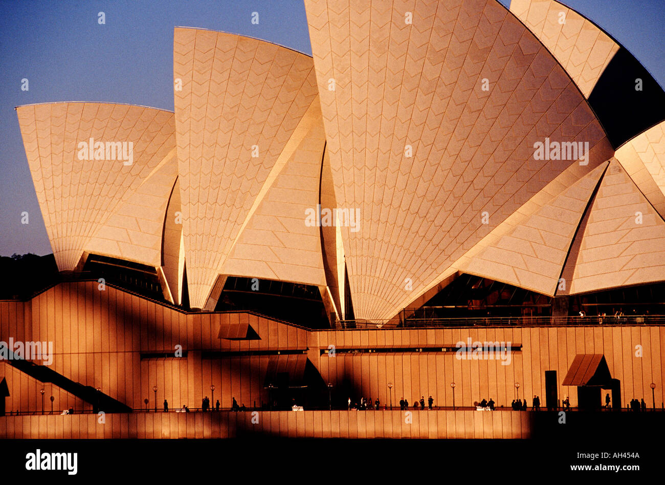 Sydney Opera House with building shells lit by warm light of a sun