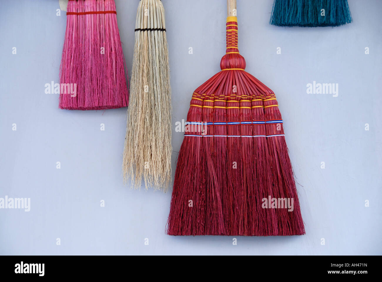 Collection of traditionally besom brooms with bristles made from corn husks. Stock Photo