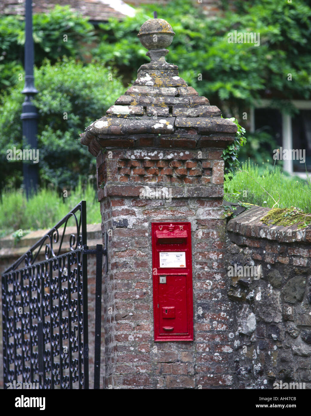 Victorian postbox set in the gate wall of a village priory in the Lincolnshire Wolds UK. Stock Photo