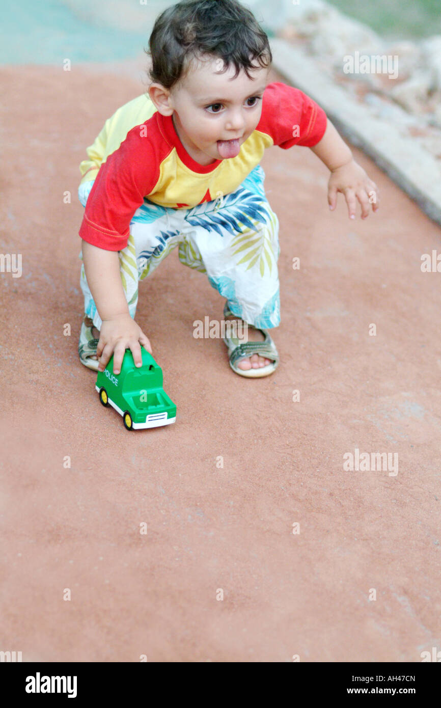 A boy plays with a toy car Stock Photo - Alamy
