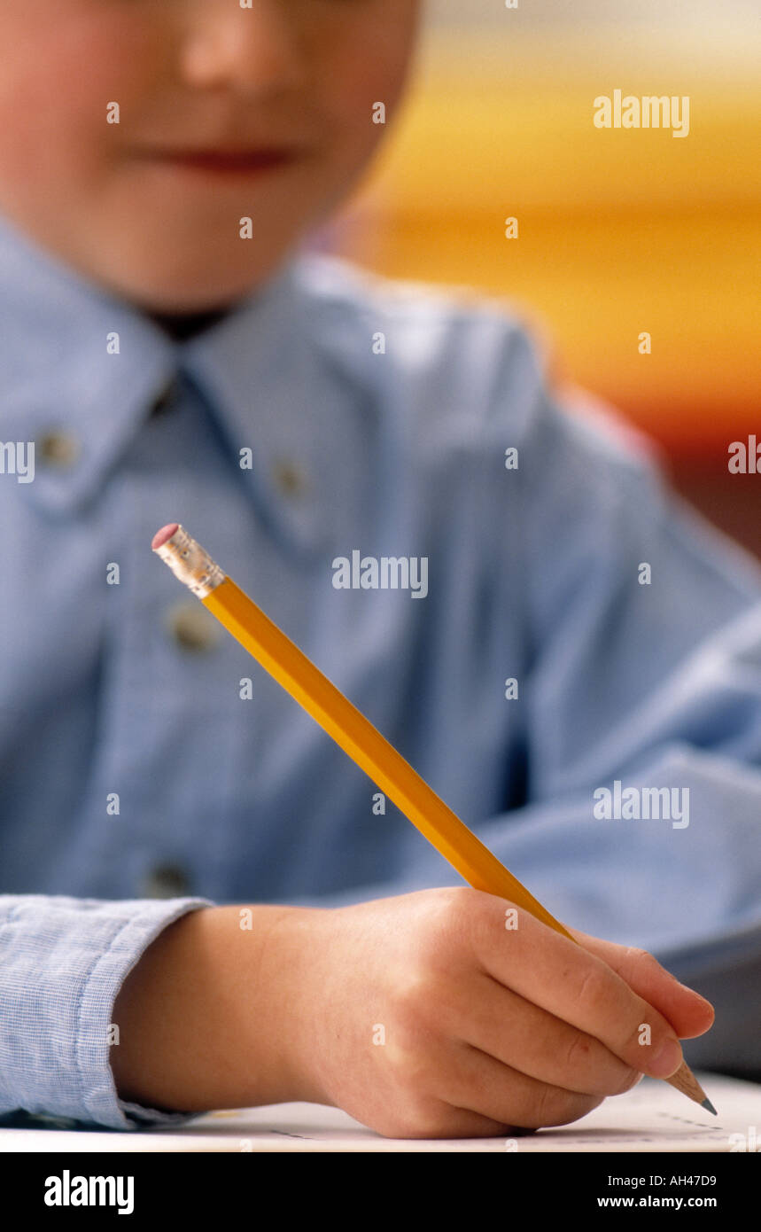 Close up of child writing at school Stock Photo