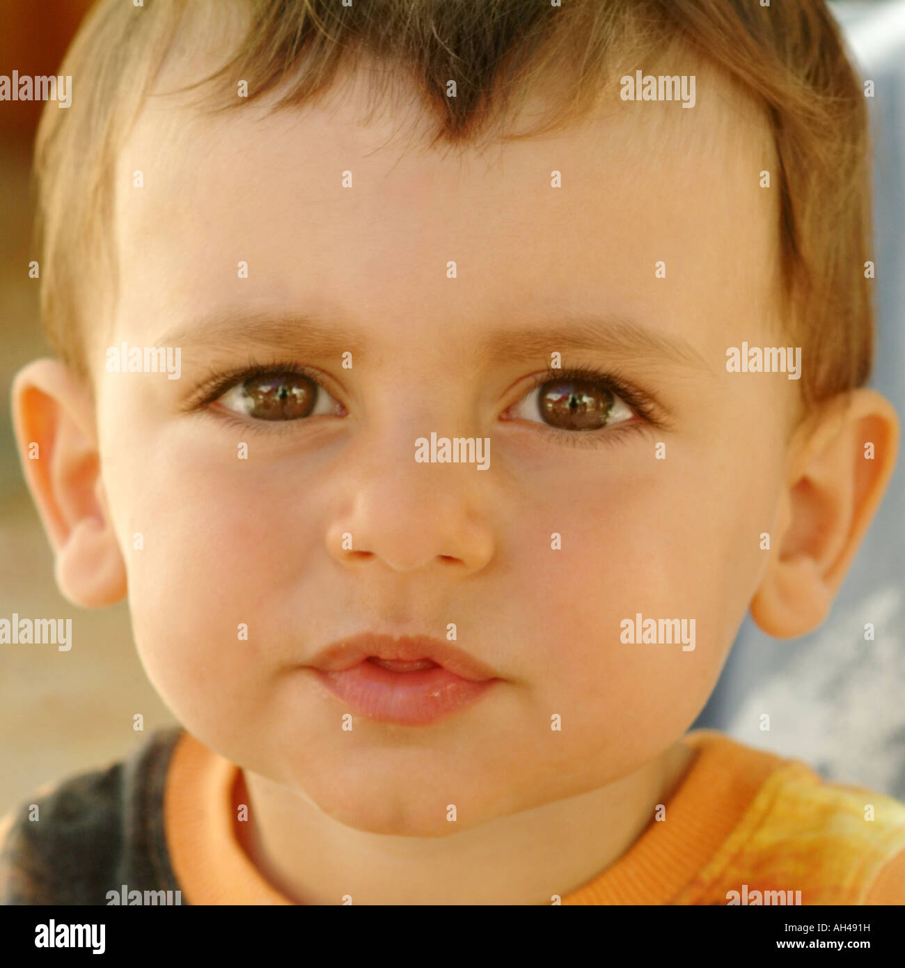 Beautiful child with big eyes and a serious expression Stock Photo