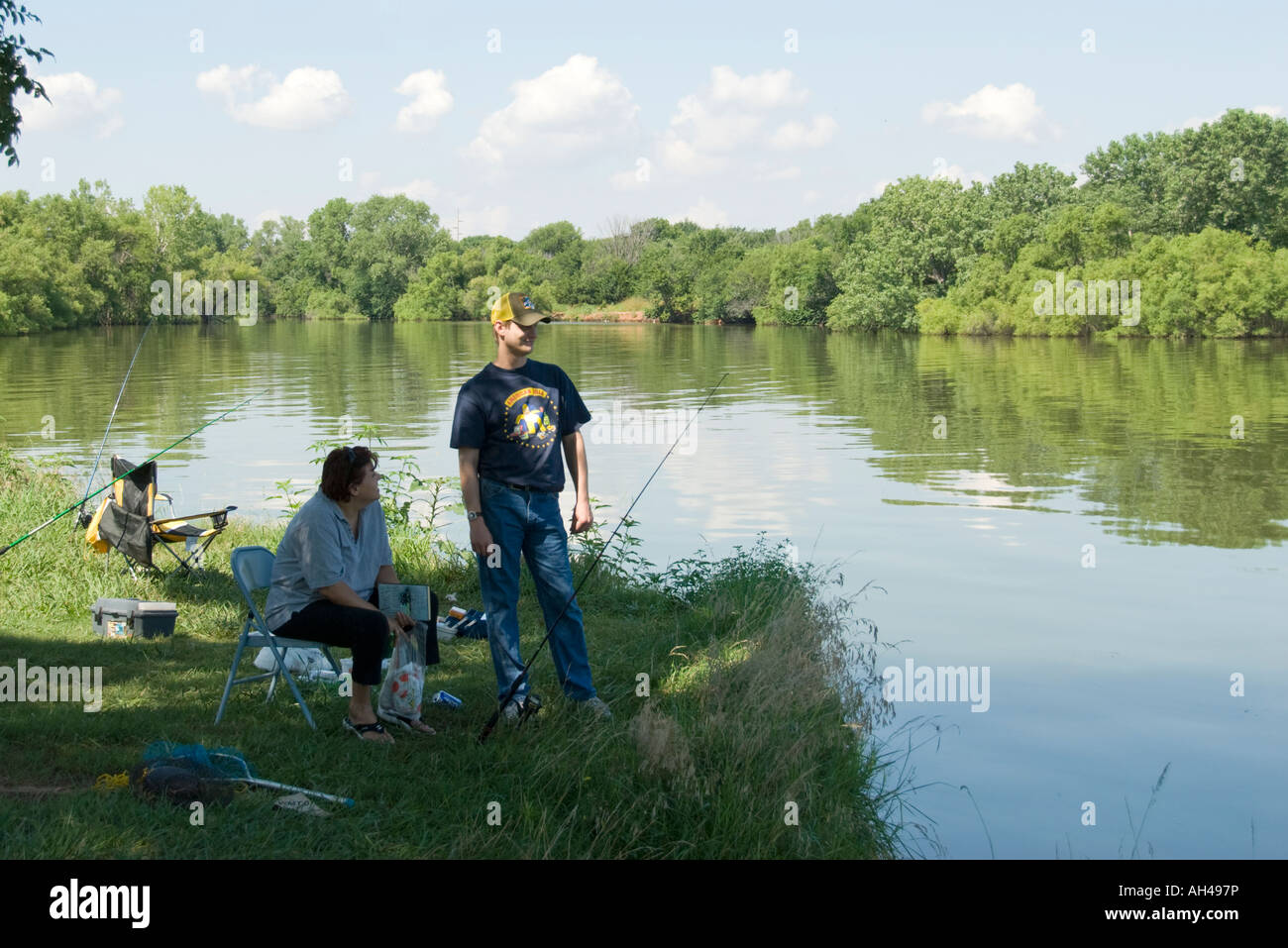 A man and woman fish in Overholser lake off the bank. Oklahoma, USA