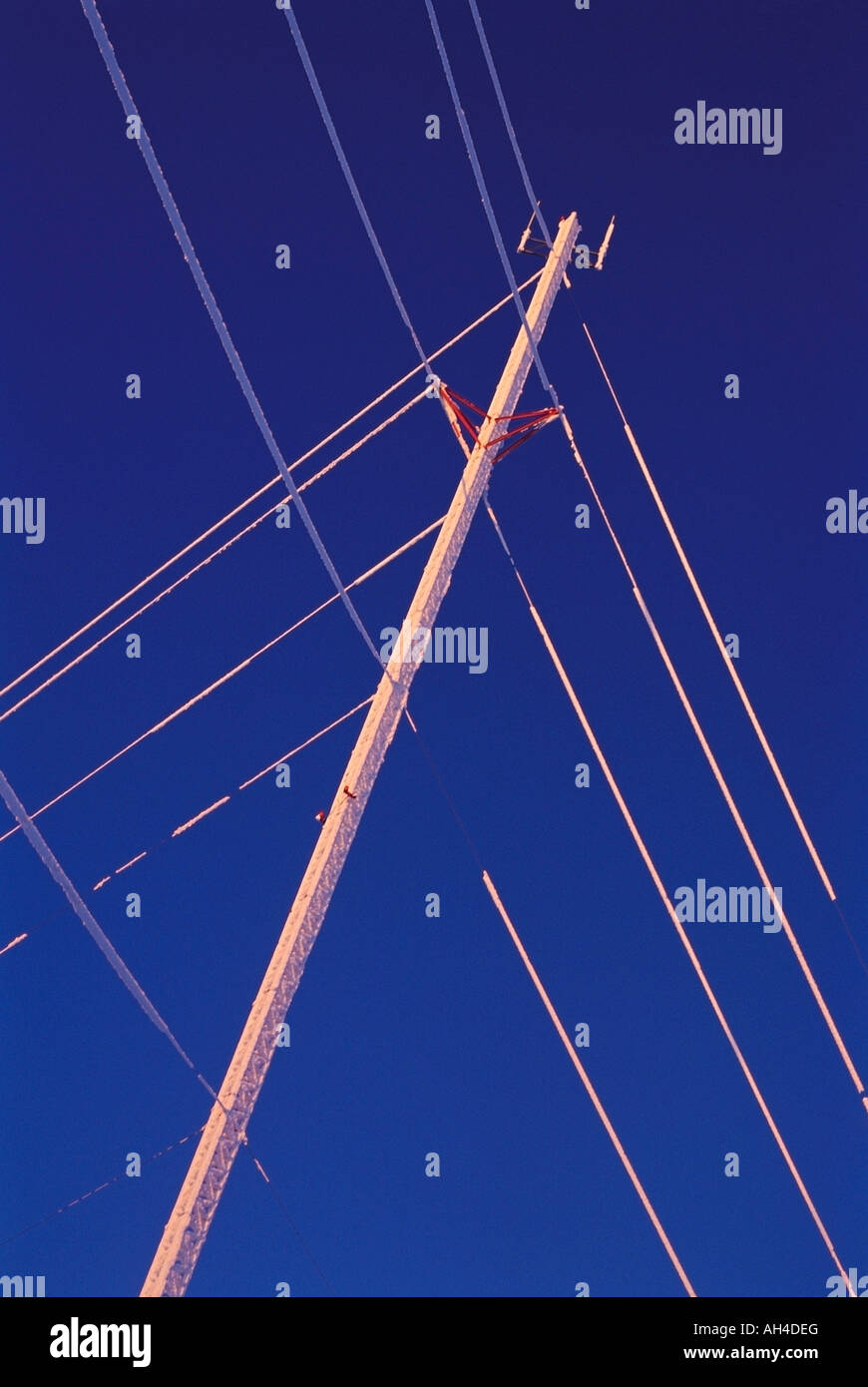 Power lines against blue sky Stock Photo - Alamy