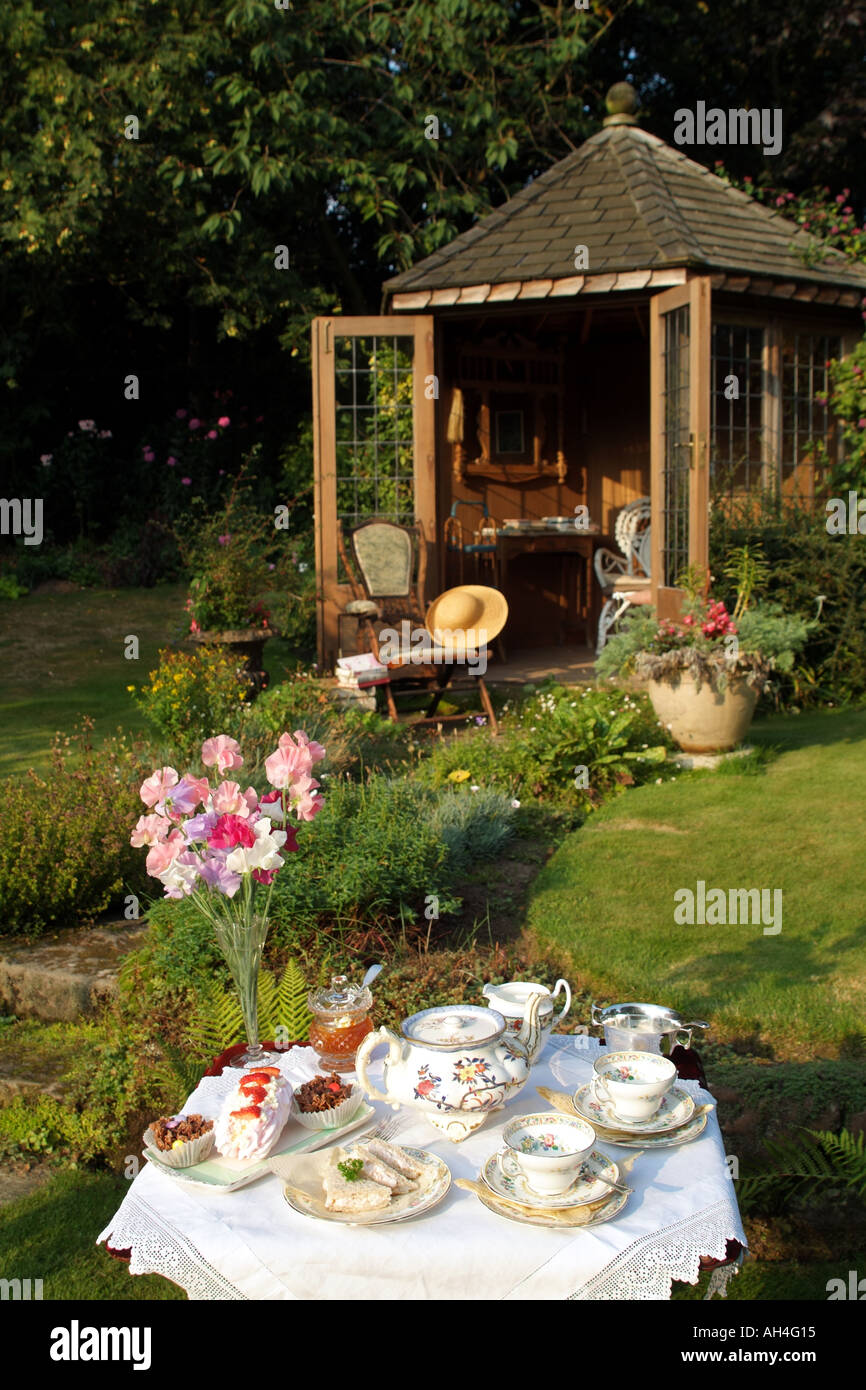 afternoon tea set on the lawn outside summer house in English country