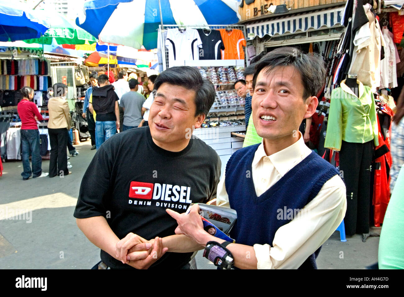 Two street peddlers sell counterfeit products at the Everything Market in Shanghai China Stock Photo