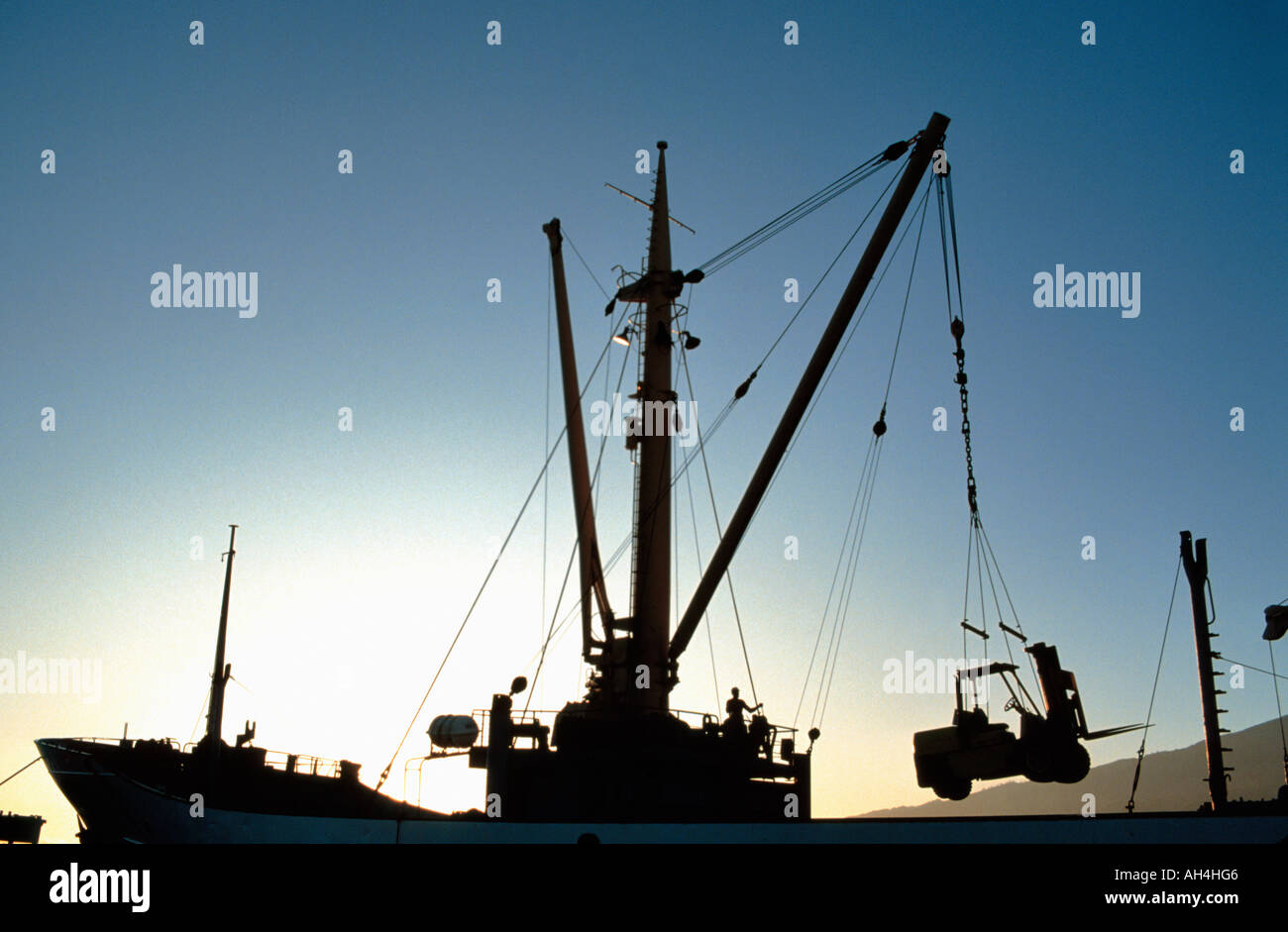 crane onboard ship lifting forklift truck, Thaiti, French Polynesia