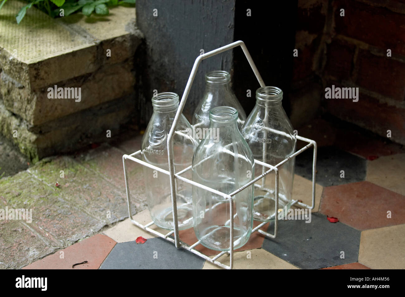 Empty glass milk bottles in crate on doorstep Stock Photo Alamy