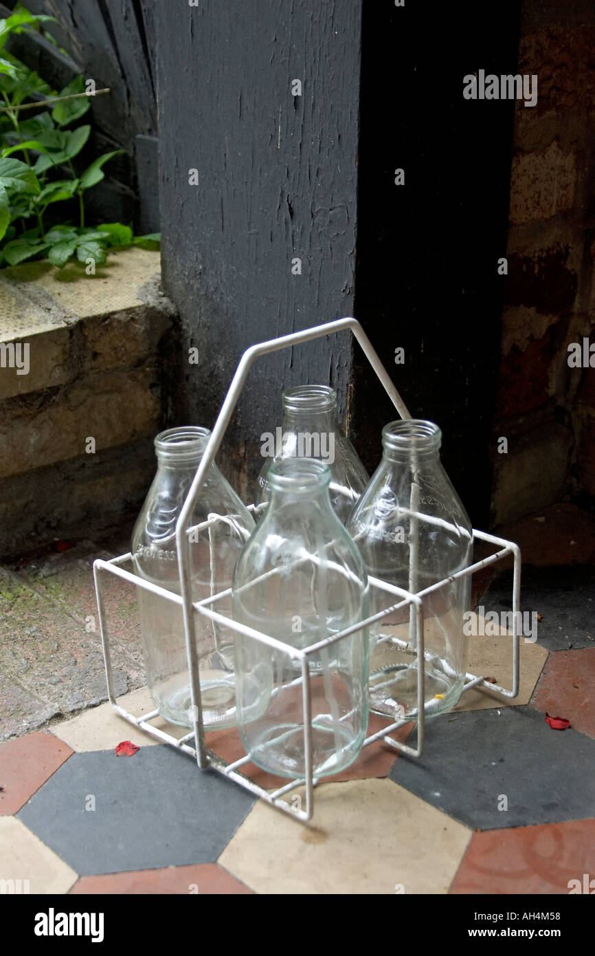 Empty glass milk bottles in crate on doorstep Stock Photo Alamy