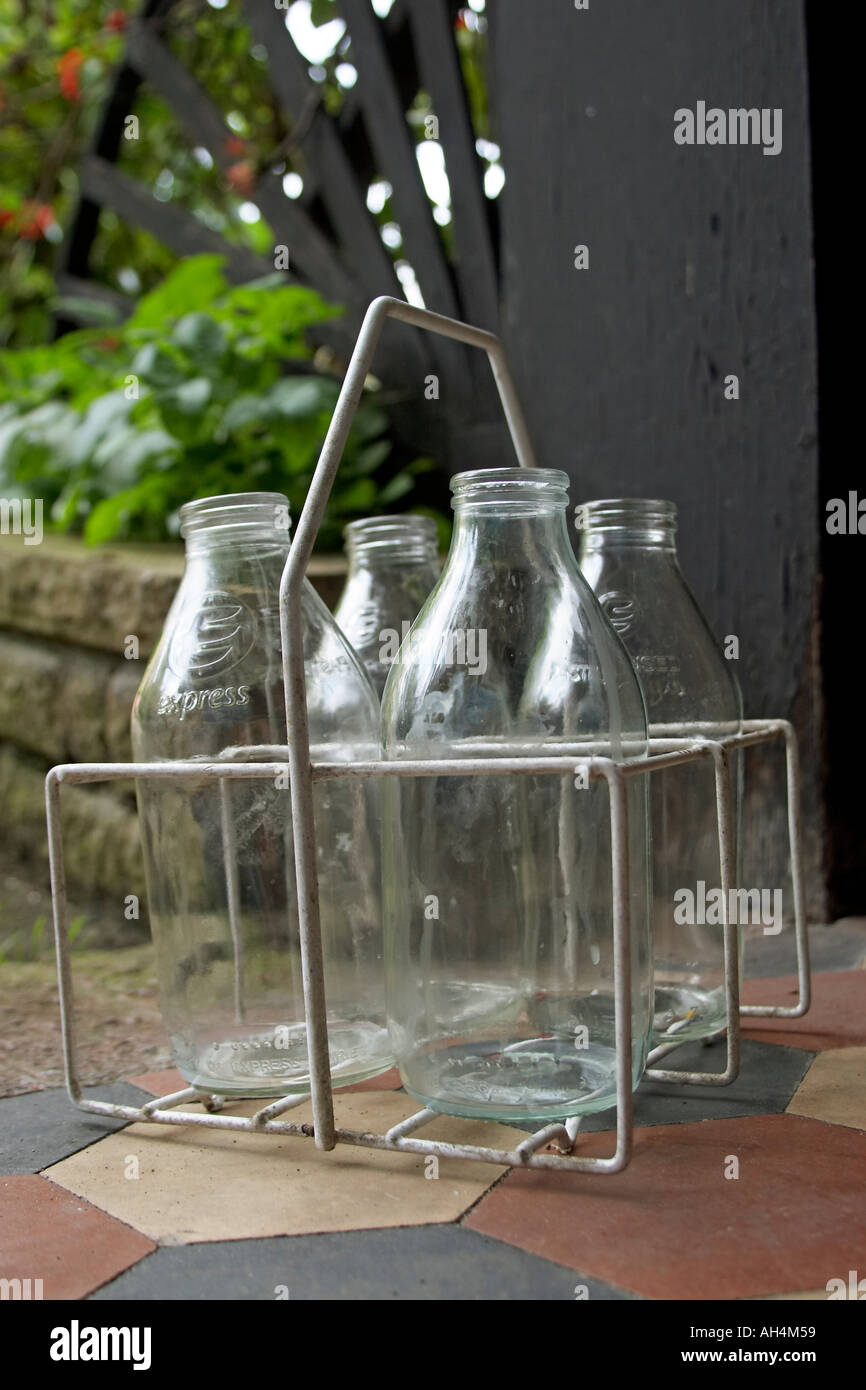 Empty glass milk bottles in crate on doorstep Stock Photo Alamy