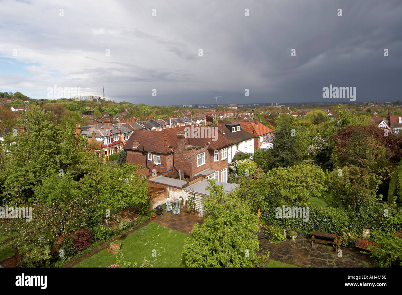 View east over suburbs houses and rooftops of Muswell Hill north London N10 warm evening light