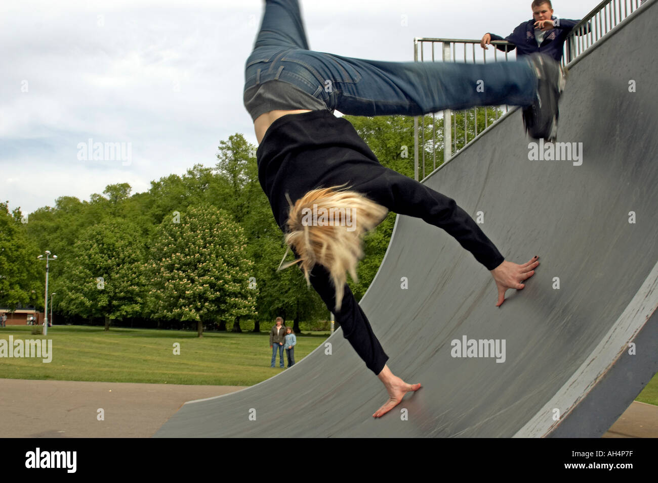 Young man or boy doing trick stunt summersault jumps on rollerblades
