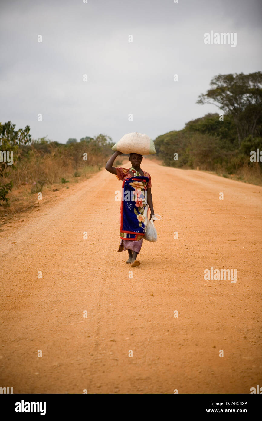 Woman in Malawi carrying sack of grain, Mchinji district, Malawi Stock Photo