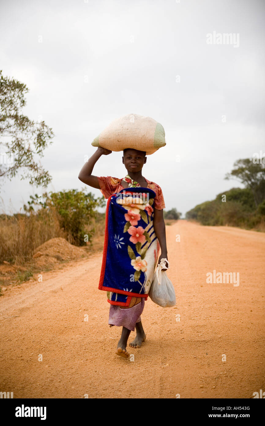 Woman in Malawi carrying sack of grain, Mchinji district, Malawi Stock Photo