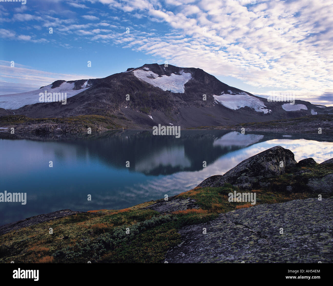 The Fannaraken peaks and an early morning mackerel sky reflecting in a