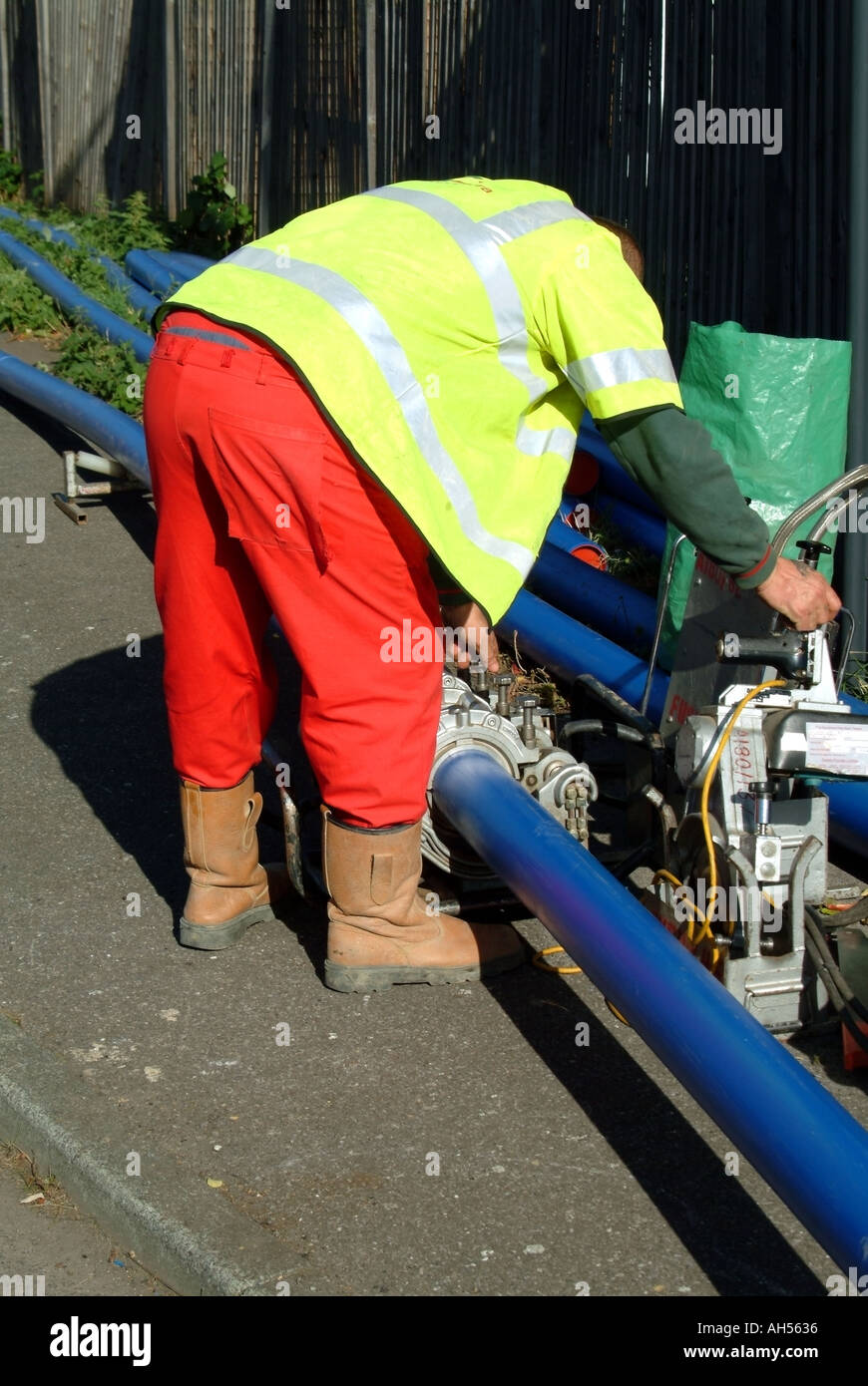Blue plastic water main pipes in welding machine to make continuous