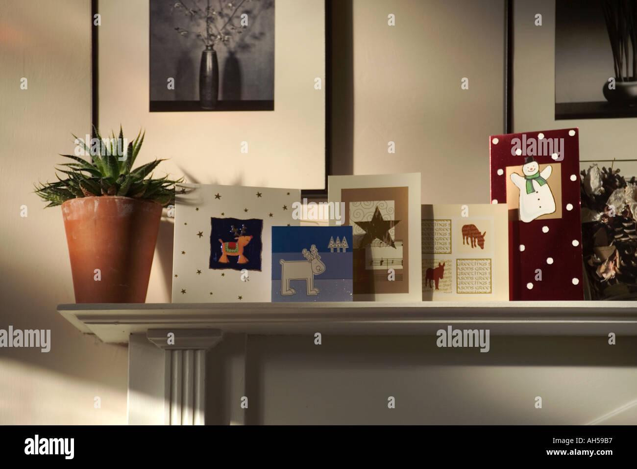 Christmas Cards On Shelf Above Fireplace In Room Of House Stock