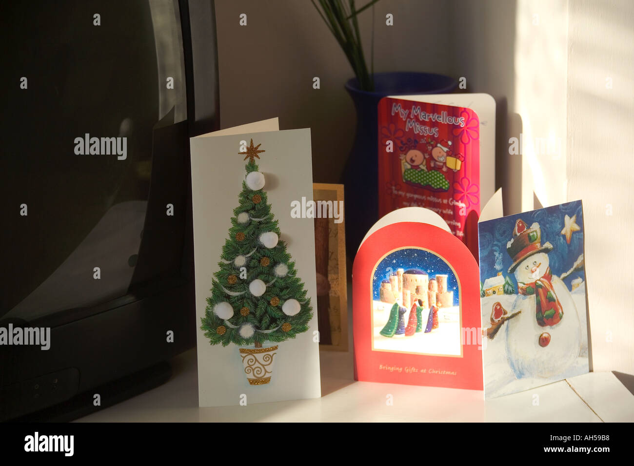 Christmas Cards On Shelf Above Fireplace In Room Of House Stock