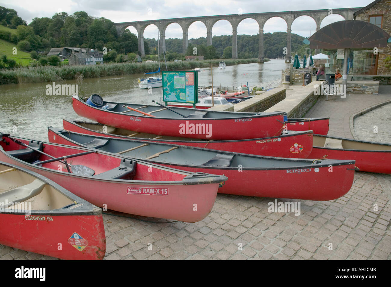 Canoes drawn up on a sllipway alongside the River Tamar Calstock Cornwall Great Britain Stock Photo