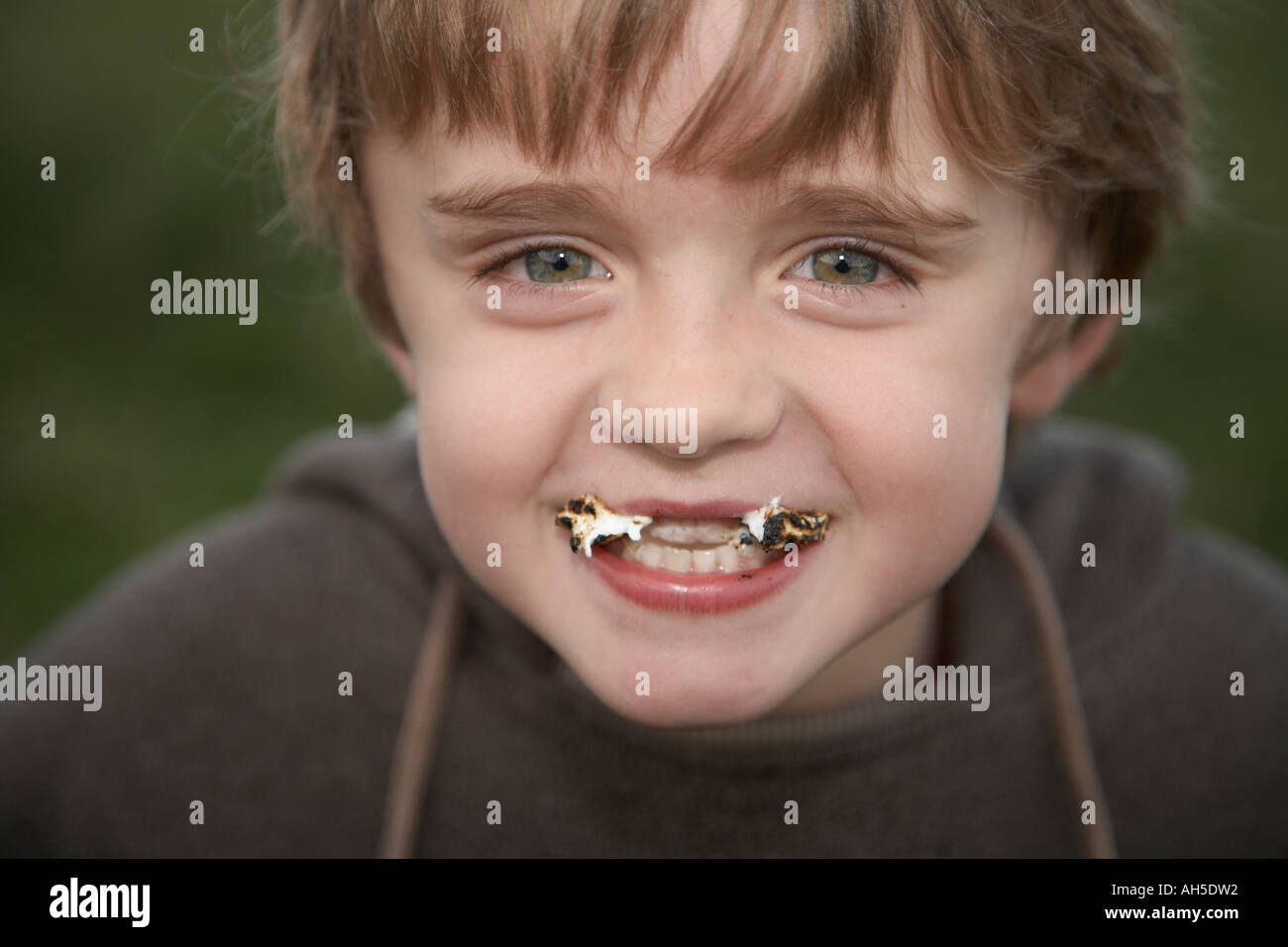 boy with mouth full of sweets Stock Photo Alamy