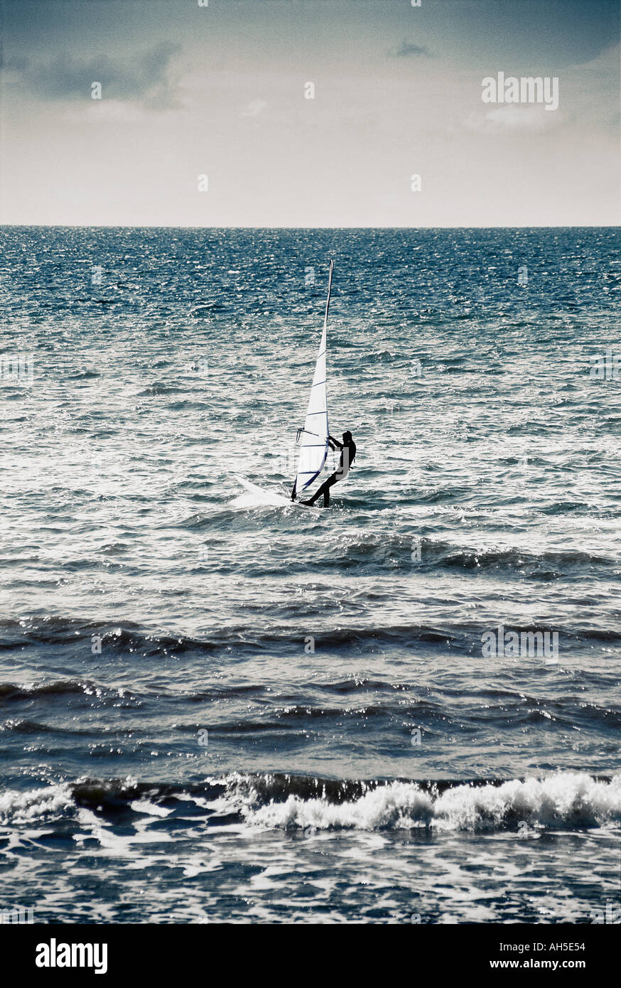 Windsurfing on waves at a coastal resort in the Lake District