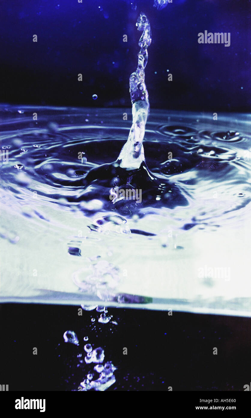 Flow of water into tank with water droplets and bubbles Stock Photo Alamy