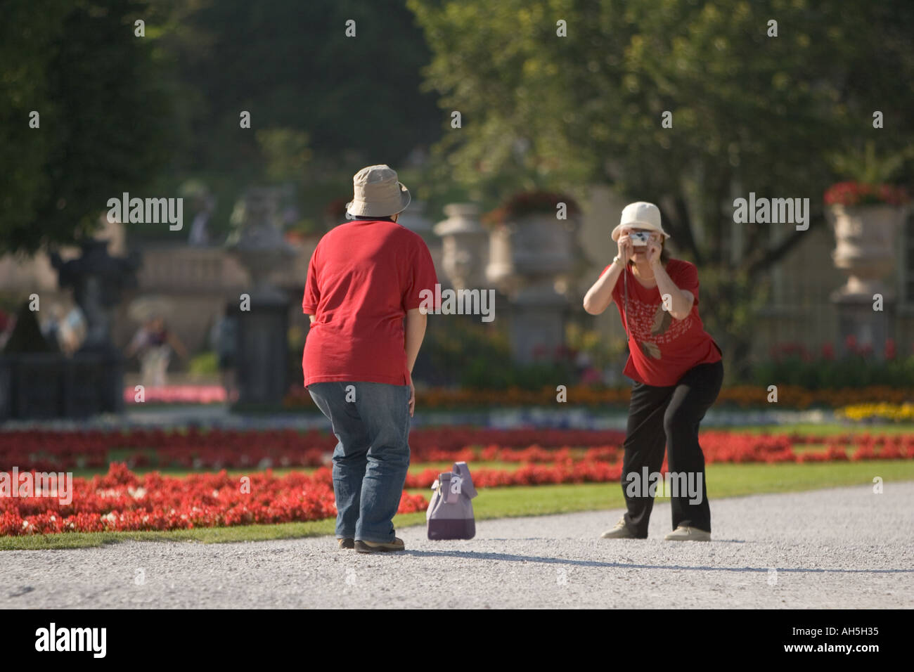 Two Japanese ladies taking a photo of each other in matching clothes red t shirts Stock Photo