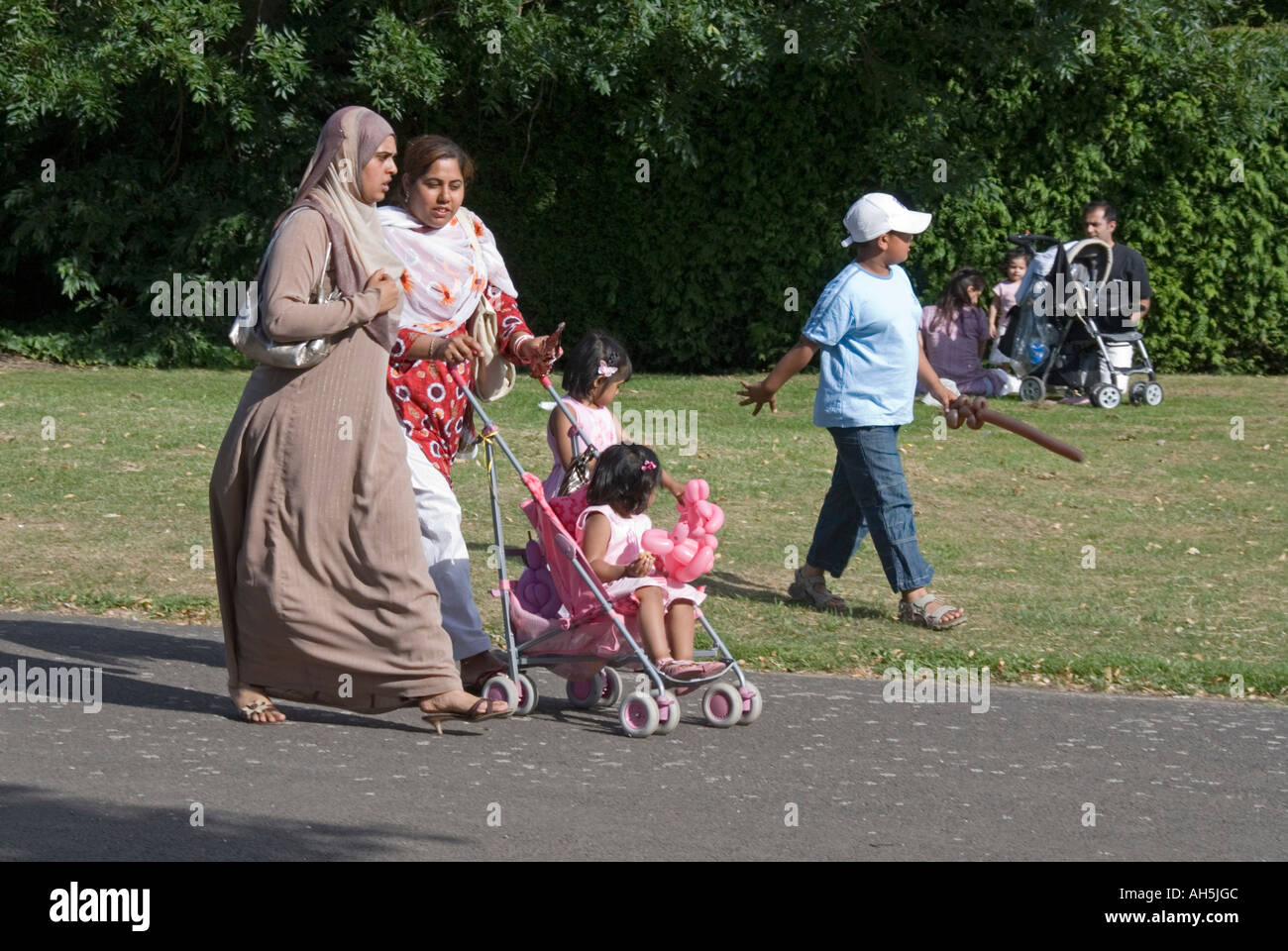 Asian family walking in the park Stock Photo - Alamy