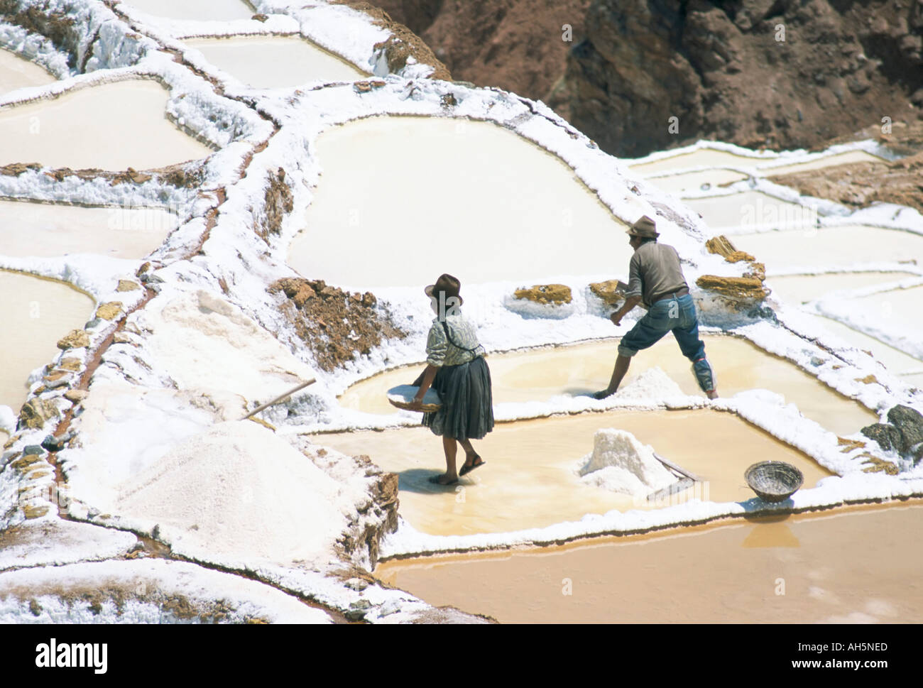 Inca salt pans below salt spring Salineras de Maras Sacred Valley Cuzco region Urabamba Peru South America Stock Photo