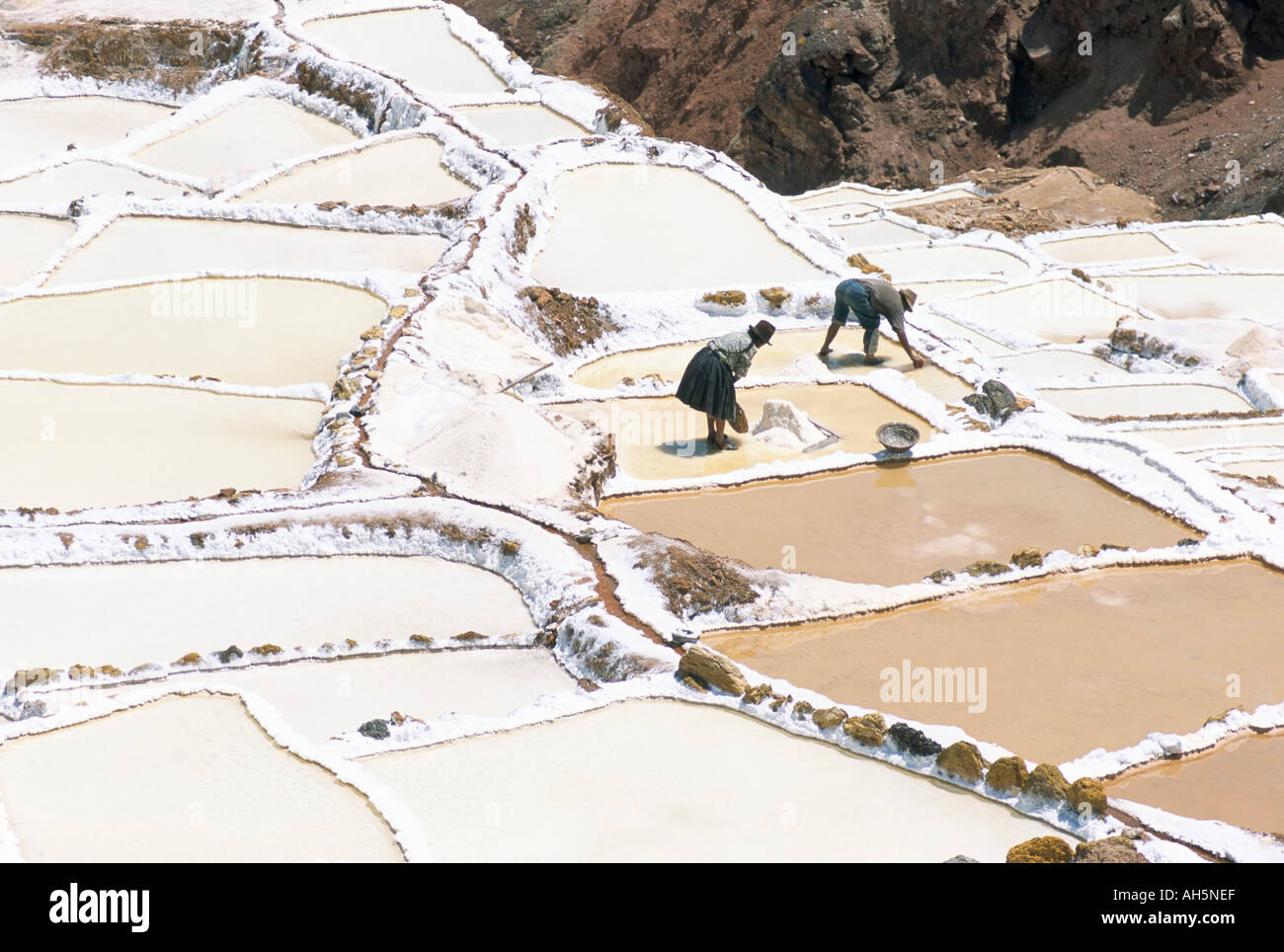 Inca salt pans below salt spring Salineras de Maras Sacred Valley Cuzco region Urabamba Peru South America Stock Photo