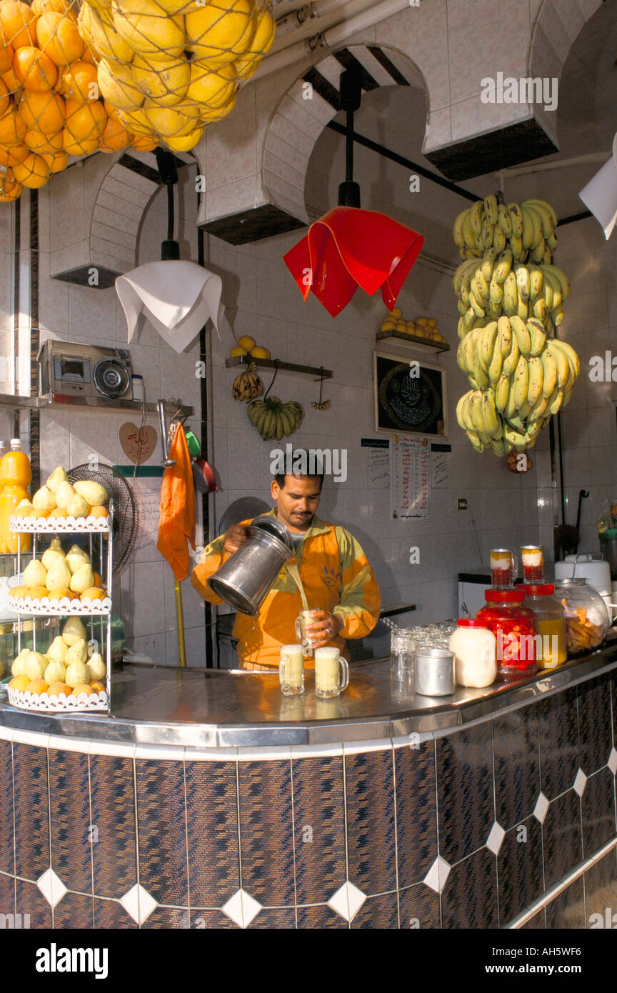 Pouring sugar cane juice juice bar Pyramids Road Cairo Egypt North