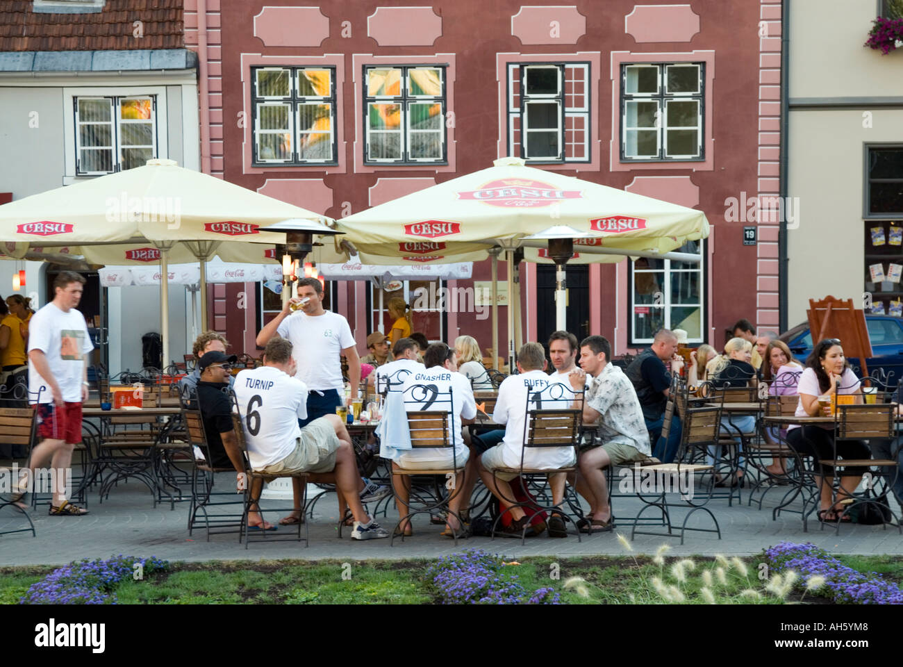 Group of English men in matching T shirts on stag weekend drinking outside bar in Livu Laukums in Riga Latvia Stock Photo