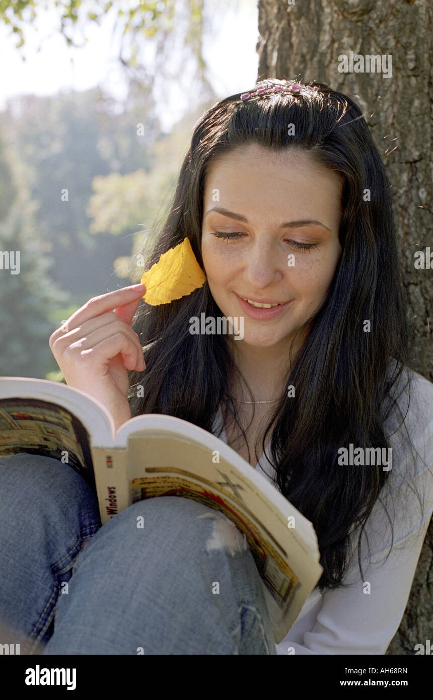 woman read a book under tree Stock Photo Alamy