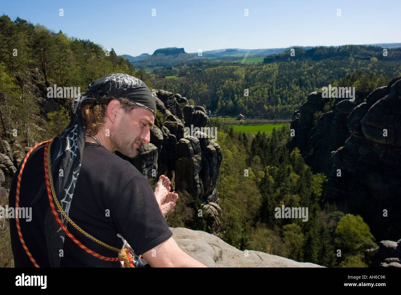 Freeclimber sitting on summit after successful climb Hirschgrund Elbe Sandstone Mountains Germany Stock Photo