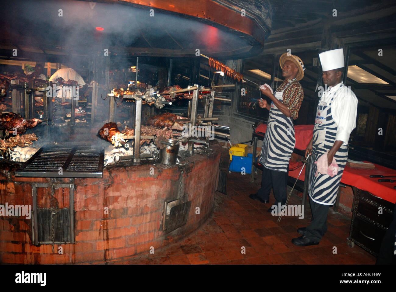 Two cooks working at the grill of the Carnivore Restaurant Nairobi Kenya East Africa Stock Photo