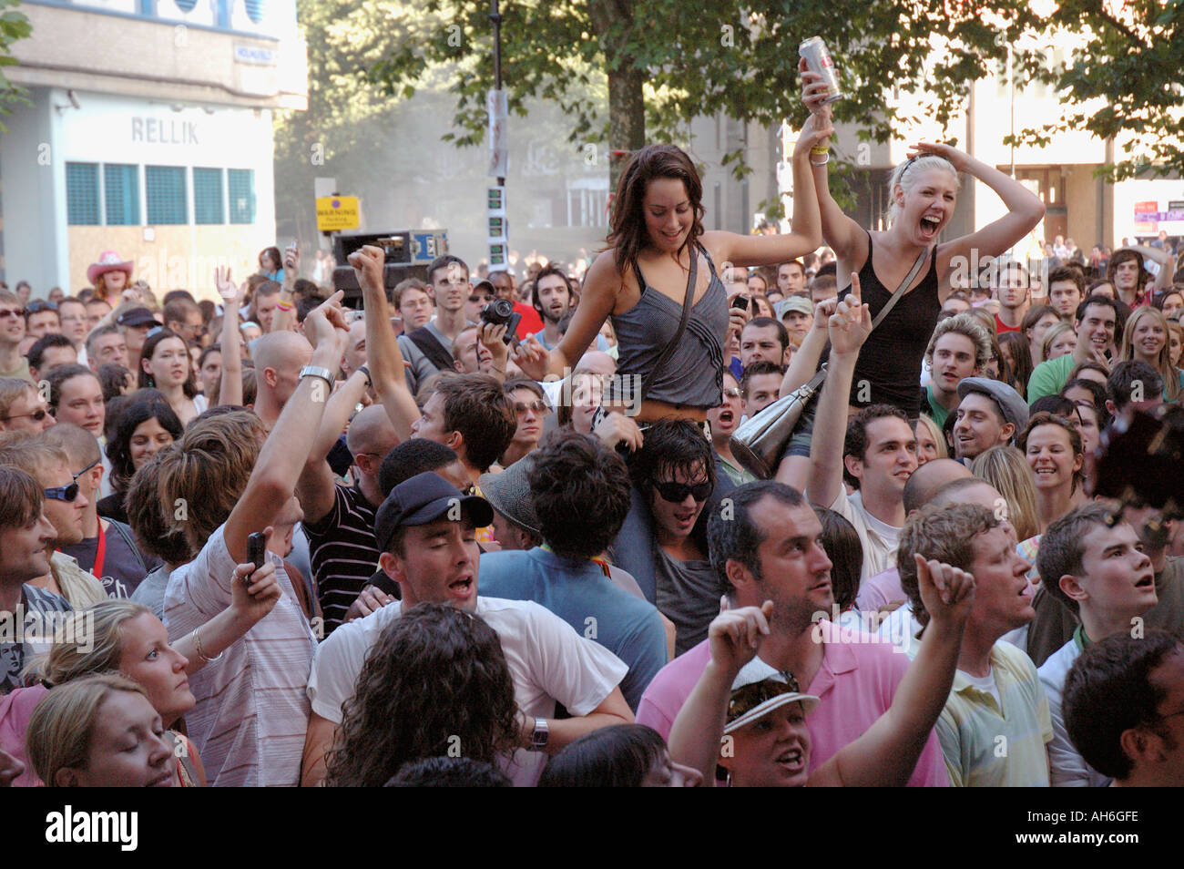 Crowd of young people dancing and cheering at street concert during Notting Hill annual carnival. Stock Photo