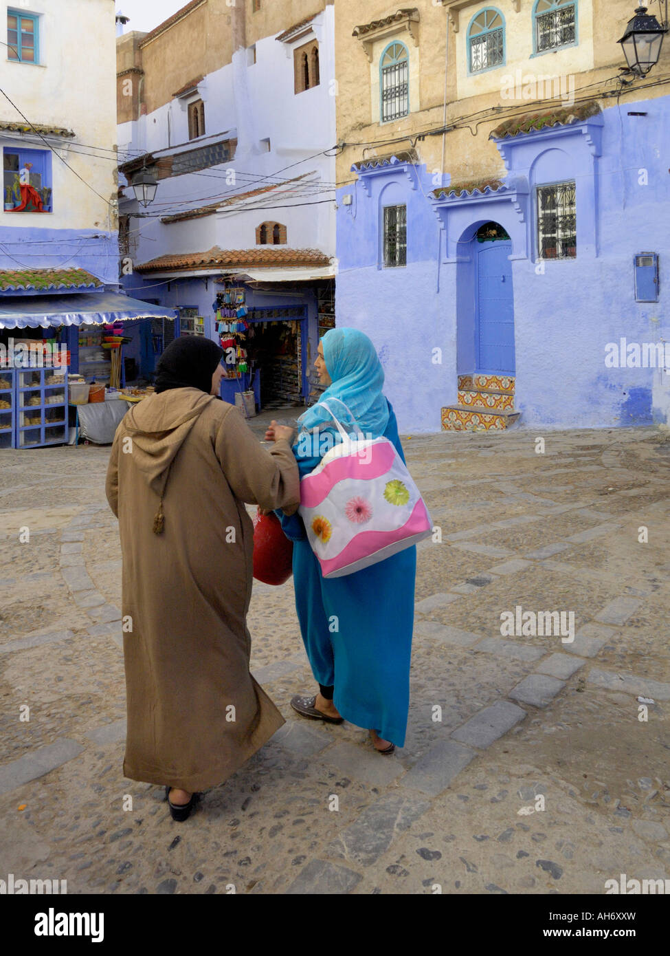 Two muslim women chatting in a square Chefchaouen Morocco North Africa Stock Photo