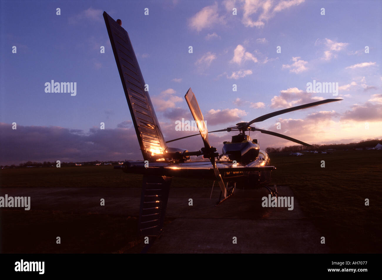 Helicopter on landing strip with sunset Stock Photo Alamy
