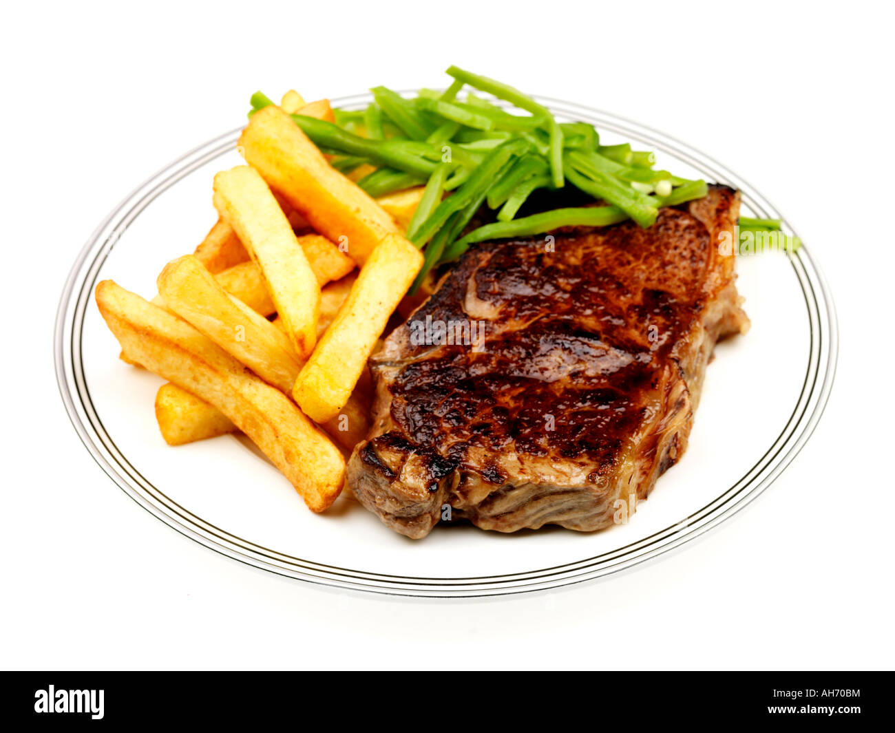 Freshly Cooked Lean Tender Sirloin Beef Steak With Chips and Green Runner Beans Against A White