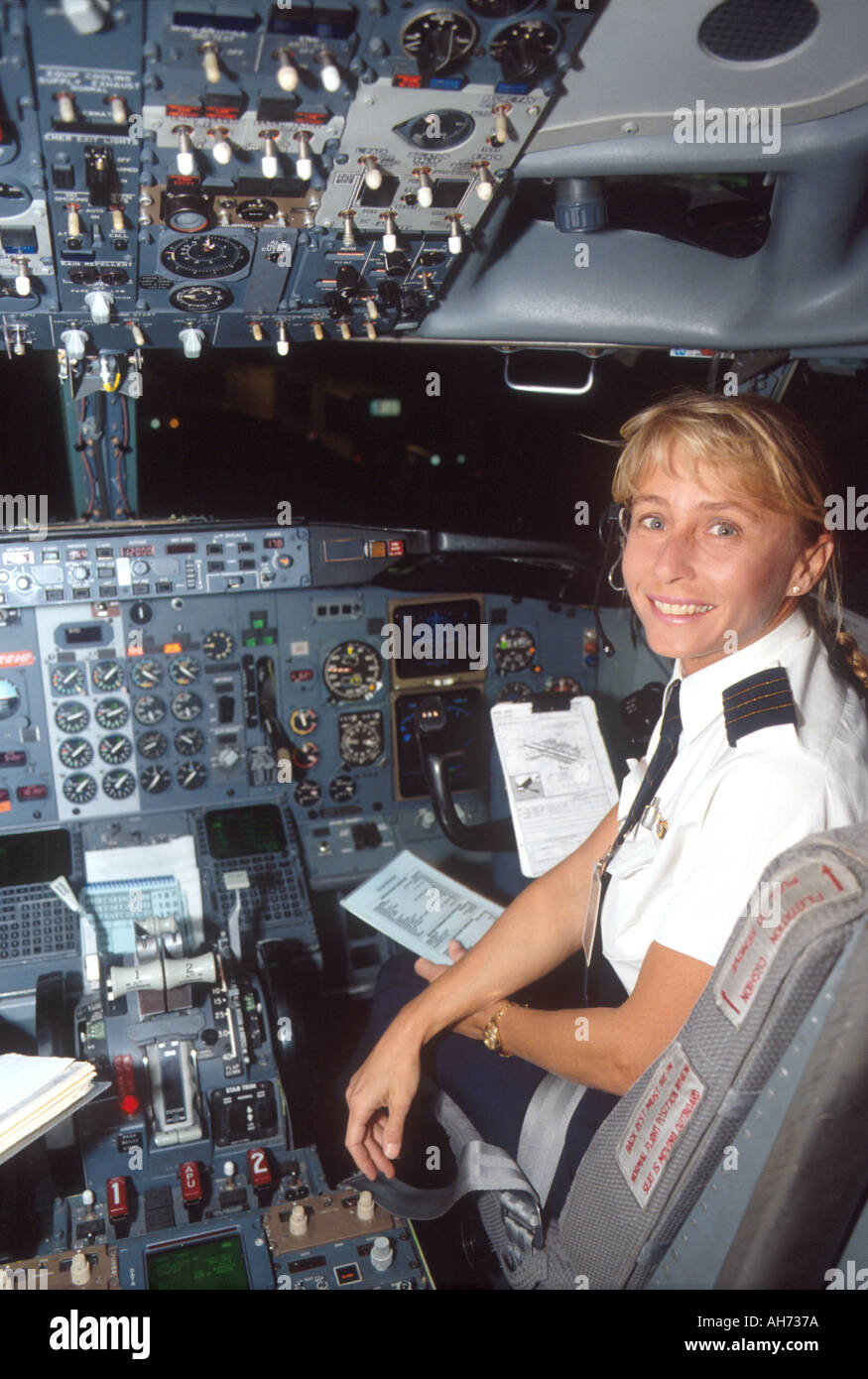 Female airline co pilot reading checklist in cockpit Stock Photo - Alamy