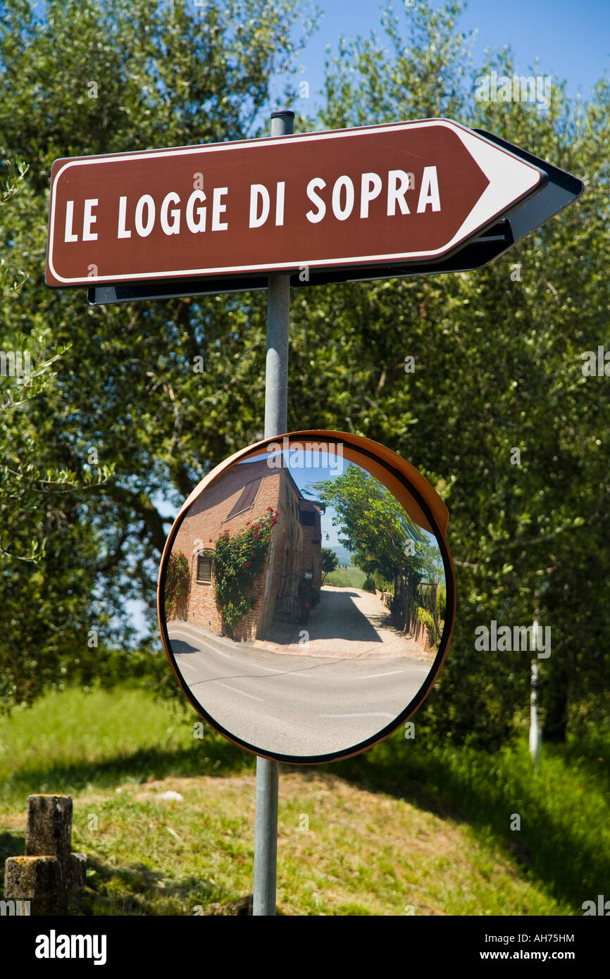 Concave mirror shows road from behind blind corner, Agriturismo Le Logge di Sopra on the Laurentina Road near Asciano, Tuscany, Stock Photo