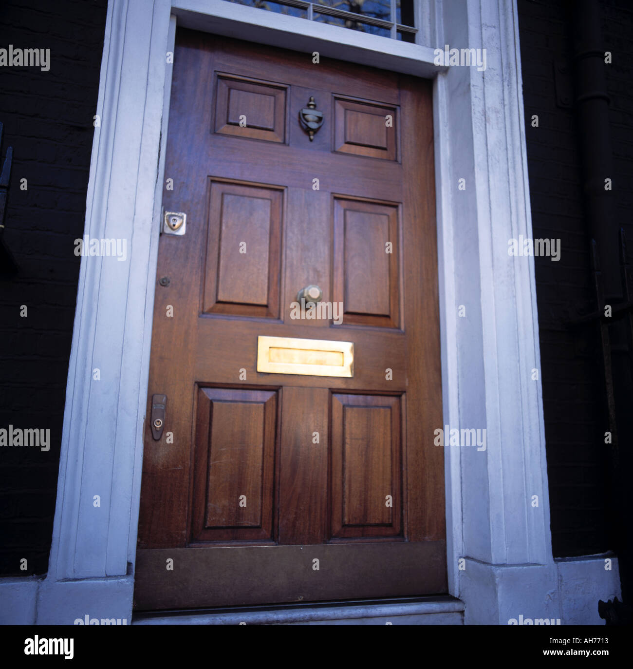 Traditional Paneled Wood Front Door With Brass Letter Box Stock
