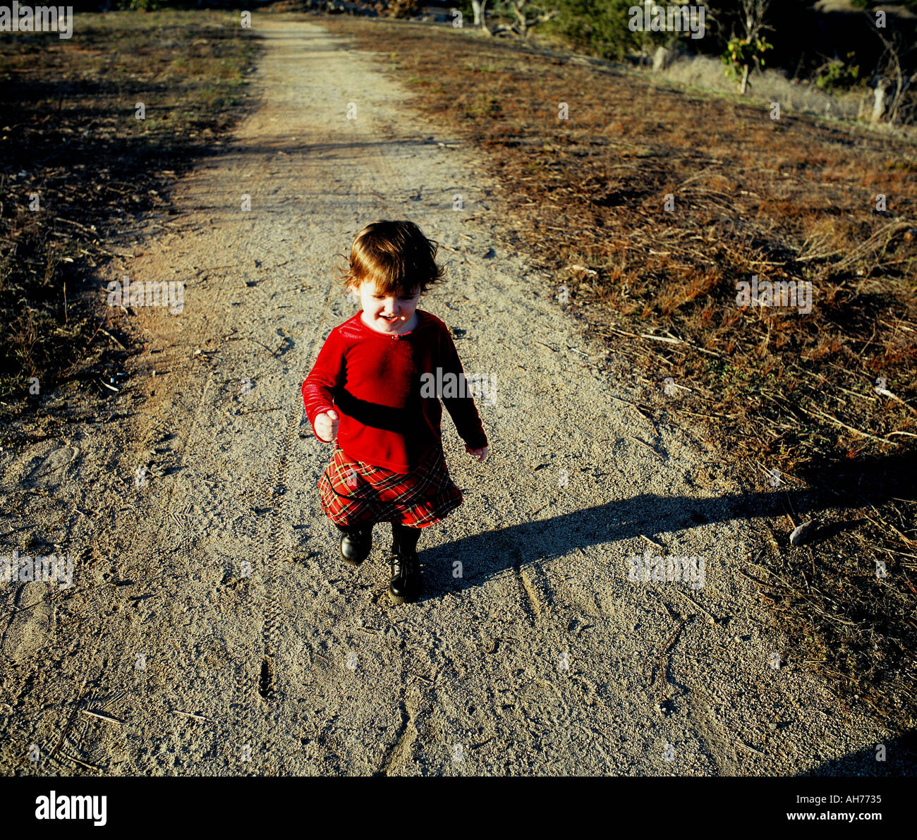 Girl walking down road hi-res stock photography and images - Alamy