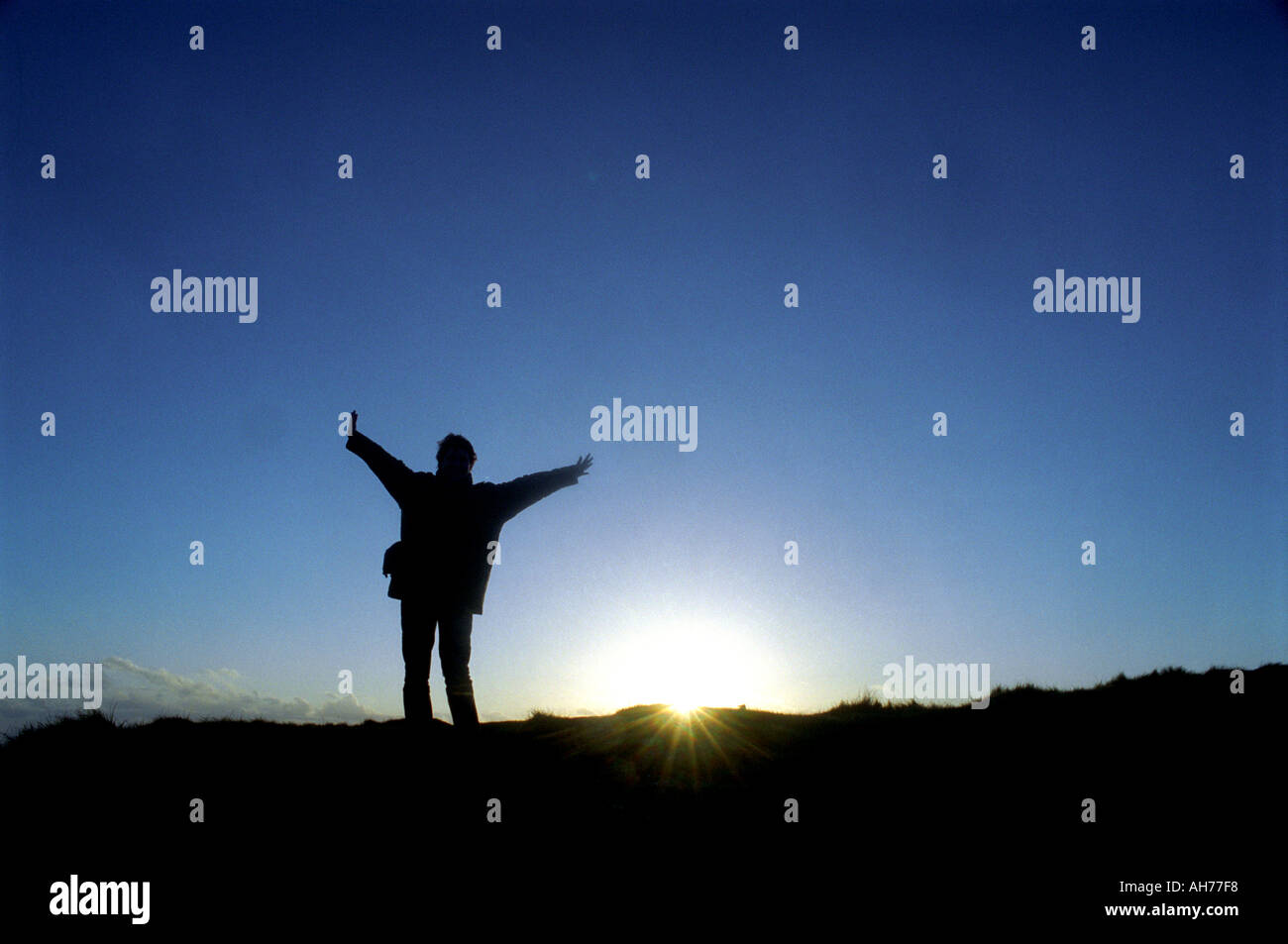Silhouette of a person with arms outstretched Stock Photo - Alamy
