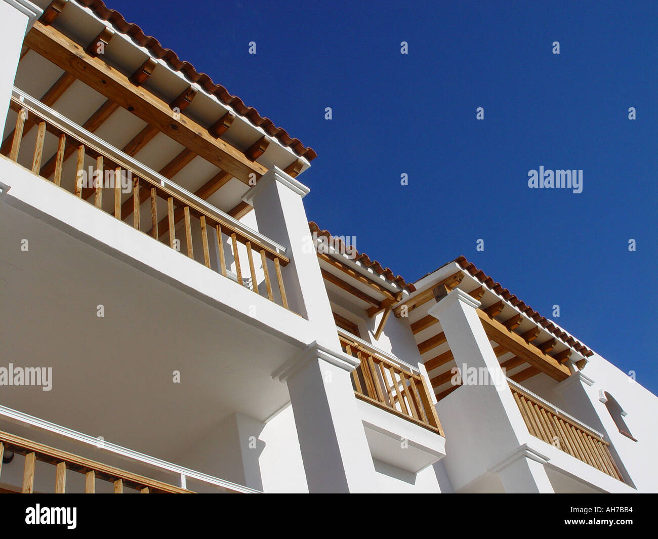 Ibiza appartment against blue sky Timber structure and balcony shown Stock Photo