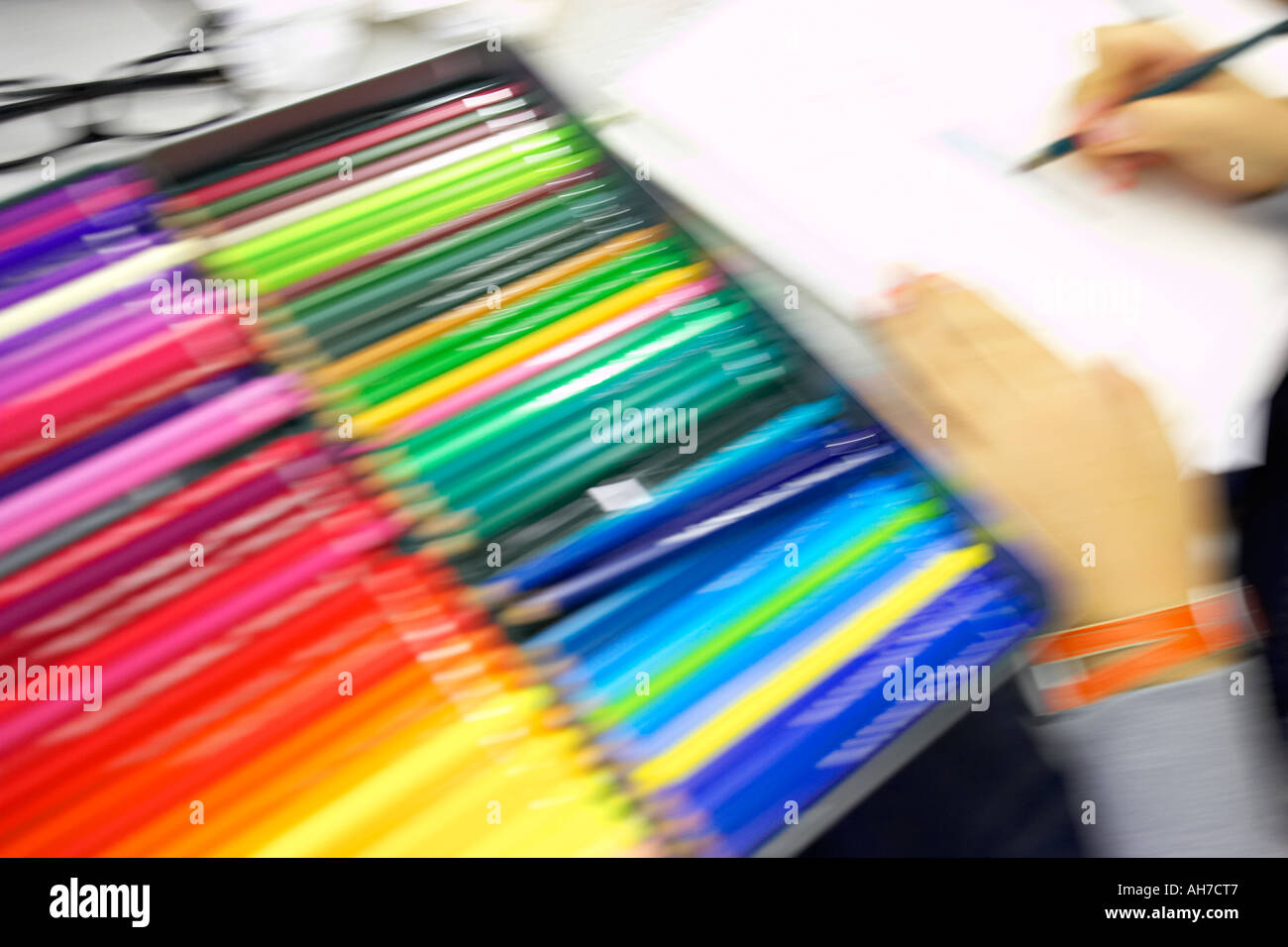 Artist designer working with color pencils artistic concept concepts conceptual attention grabbing bright busy colorful conflict Stock Photo