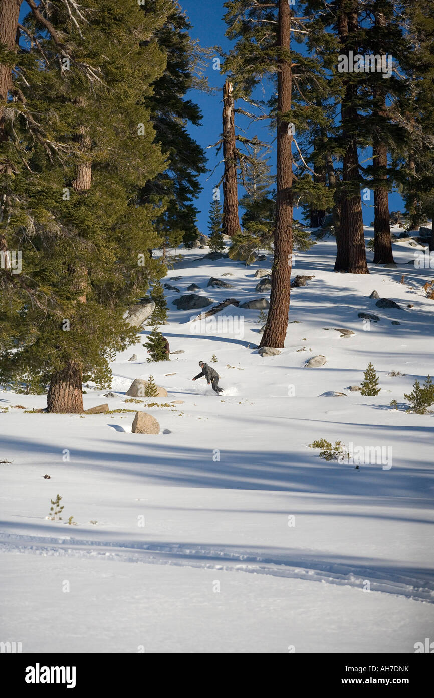 Person snowboarding down a slope Stock Photo