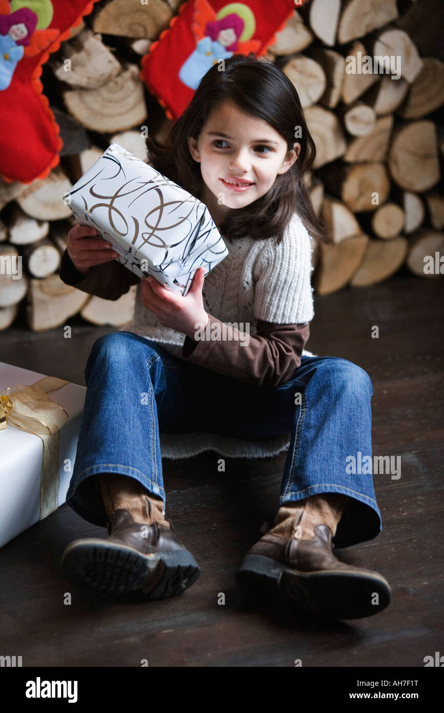 Girl holding a Christmas present Stock Photo Alamy
