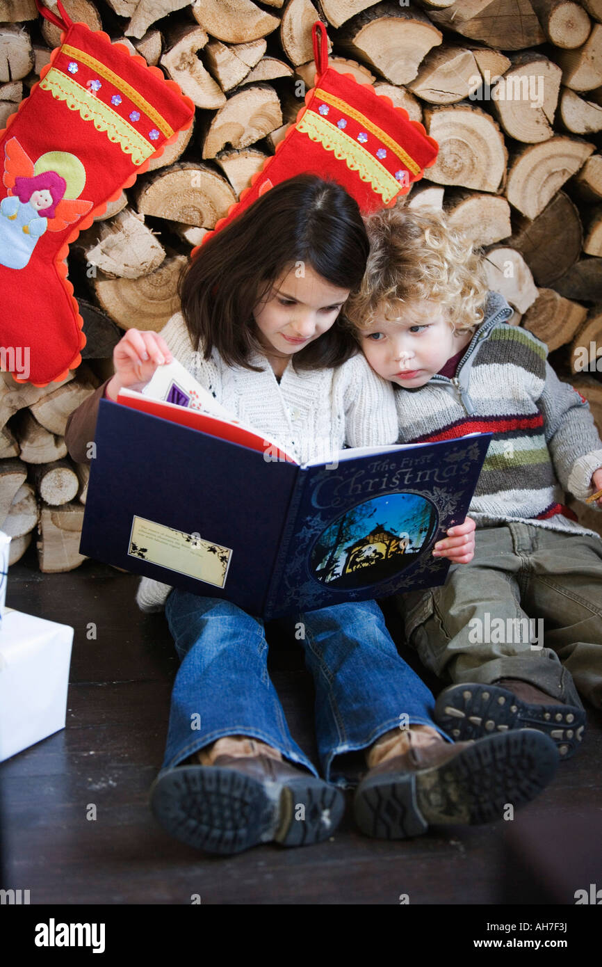 Girl and boy reading a book Stock Photo